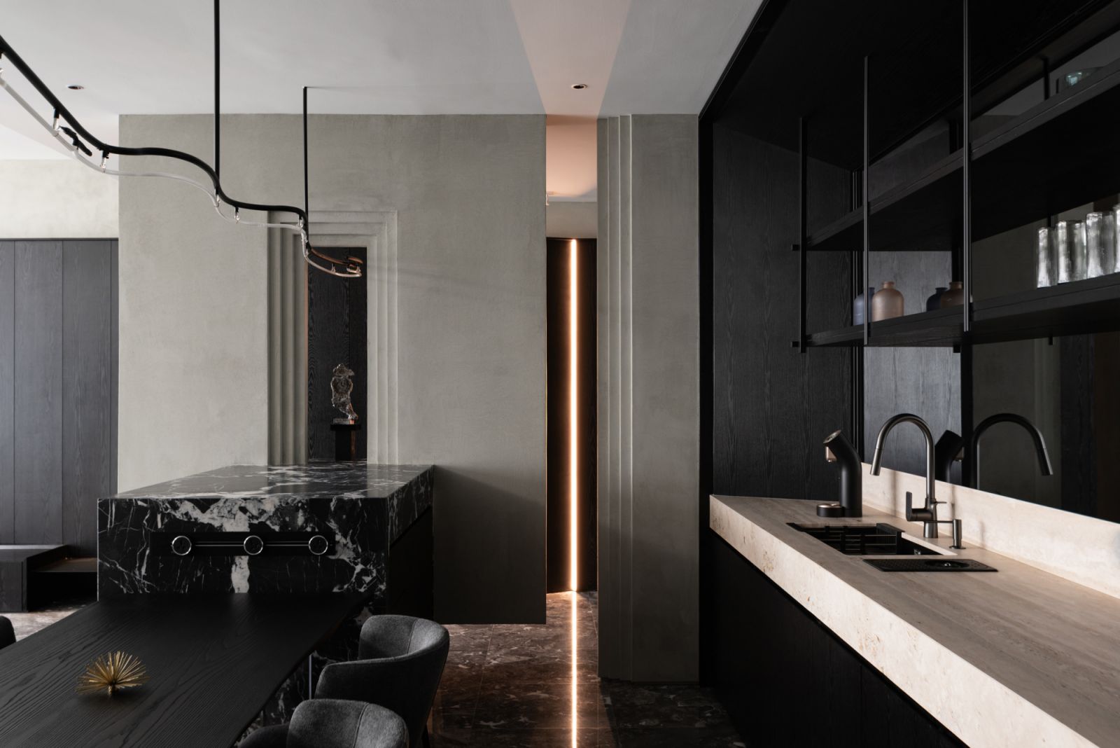 The dry kitchen is punctuated by a custom neon pendant inspired by the owners' marriage emblem