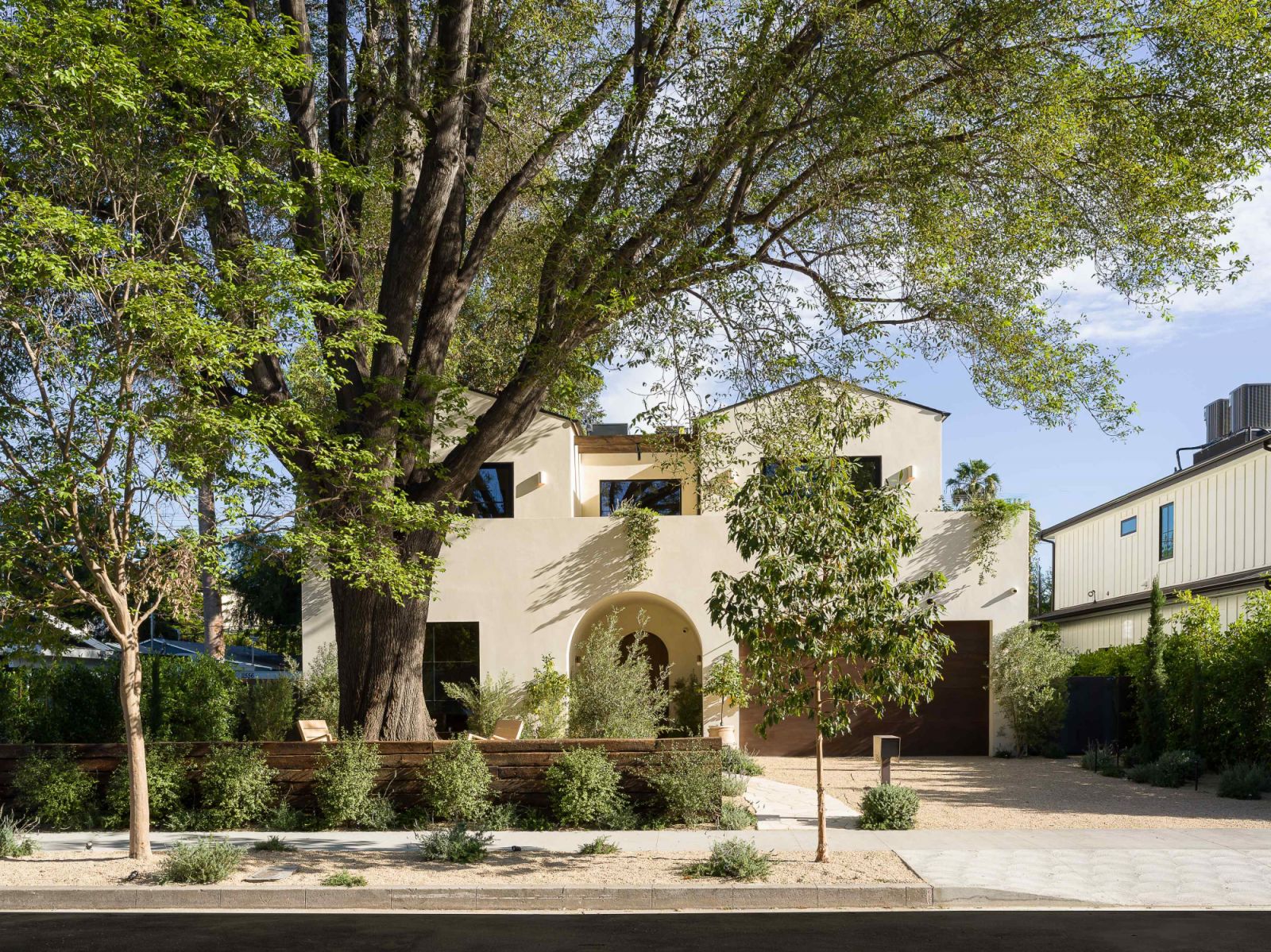 The two-storey residence is shrouded by the existing mature trees of the property