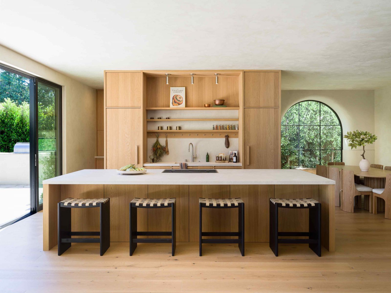 White oak flooring correlates with the wooden cabinetry in the kitchen area