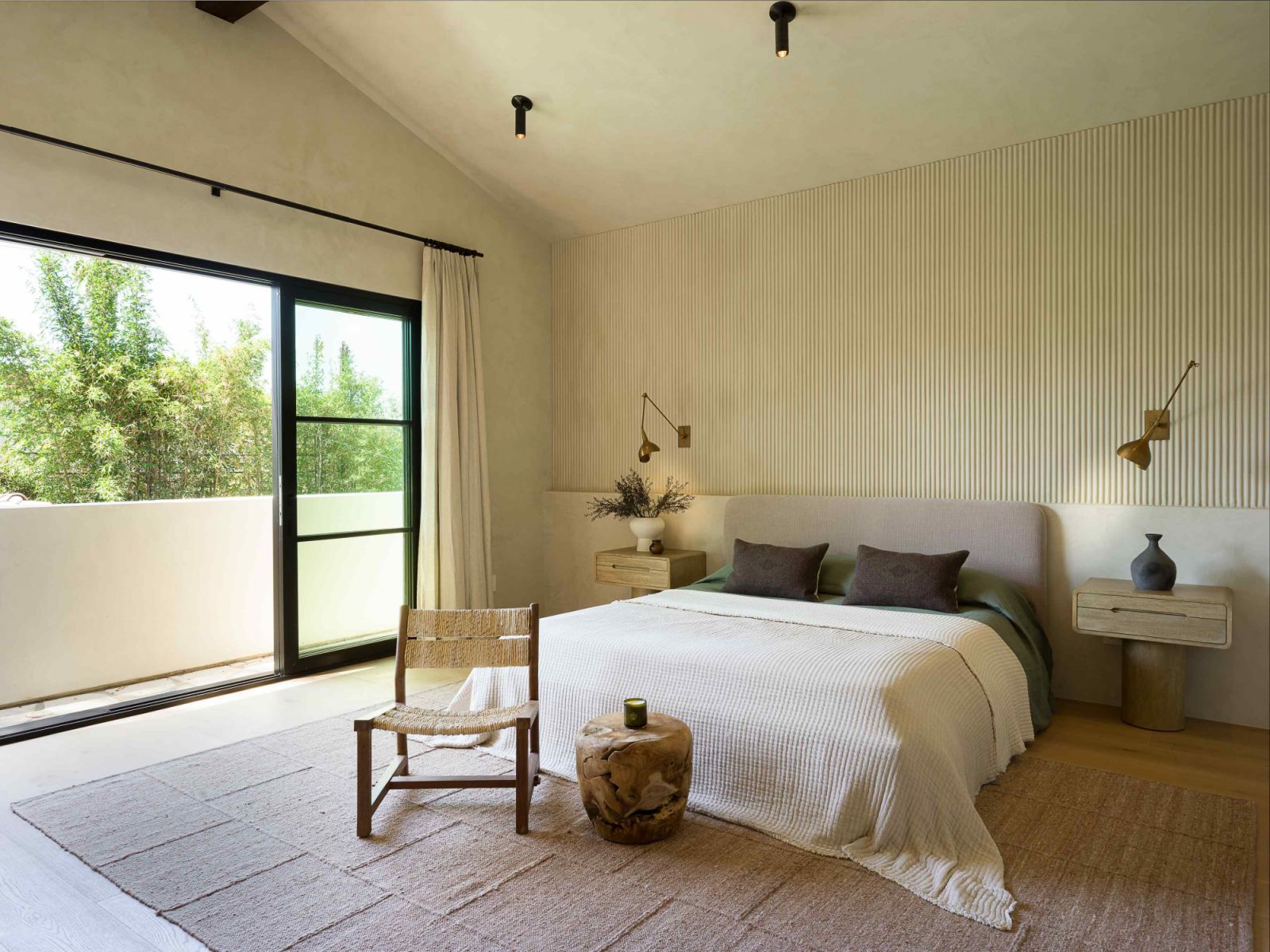 The airy, zen-like primary bedroom on the second floor