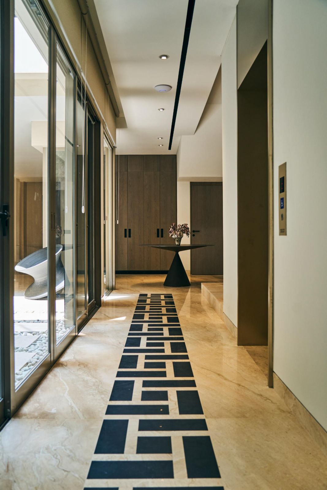 Angular marble floor patterns reinforce the design language of the home