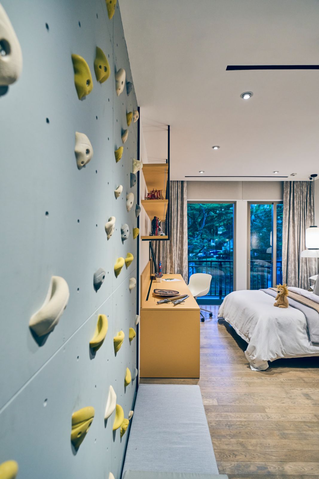 This children’s bedroom features a climbing wall
