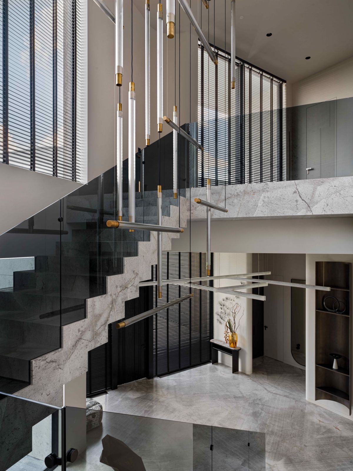 A suspended chandelier by Henge hangs off the soaring four-metre hallway ceiling
