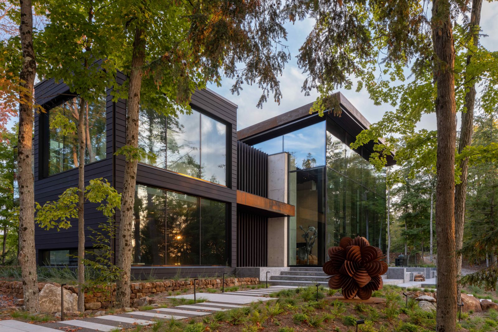 The lodge-inspired residence spans across three storeys through natural and layered, spaces that feel both grounding and restorative
