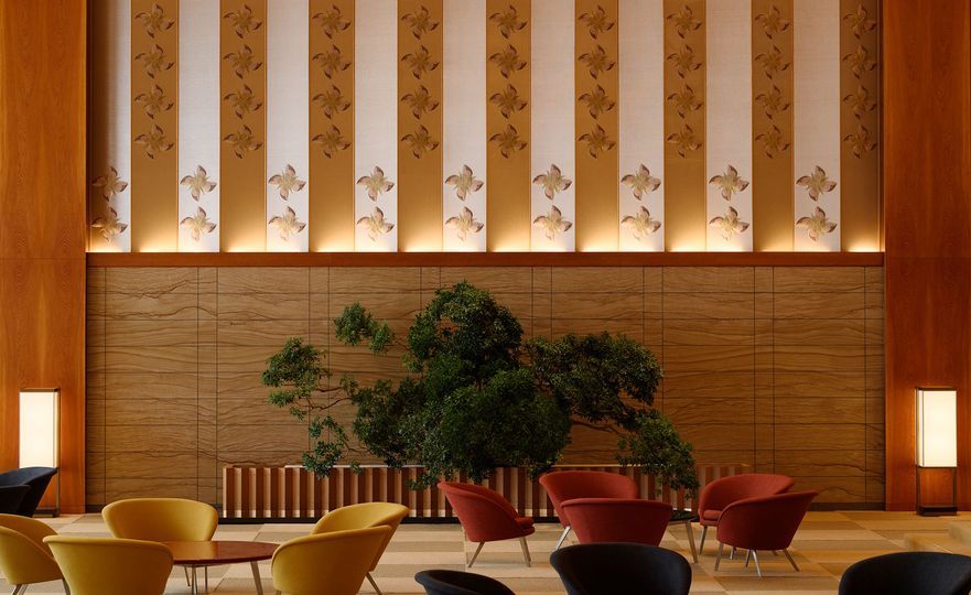 Traditional Japanese motifs meet modernist sensibilities in Hotel Okura’s backlit wall panels and warm timber detailing (Photo: Hotel Okura Tokyo)