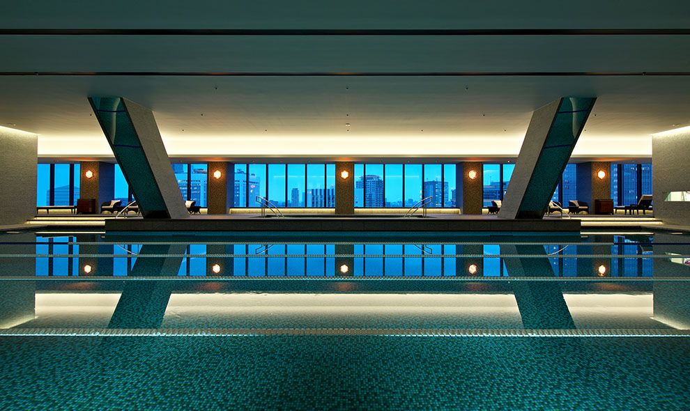 Geometric swimming pool at Hotel Okura showcasing modernist design principles with dramatic city views (Photo: Hotel Okura Tokyo)