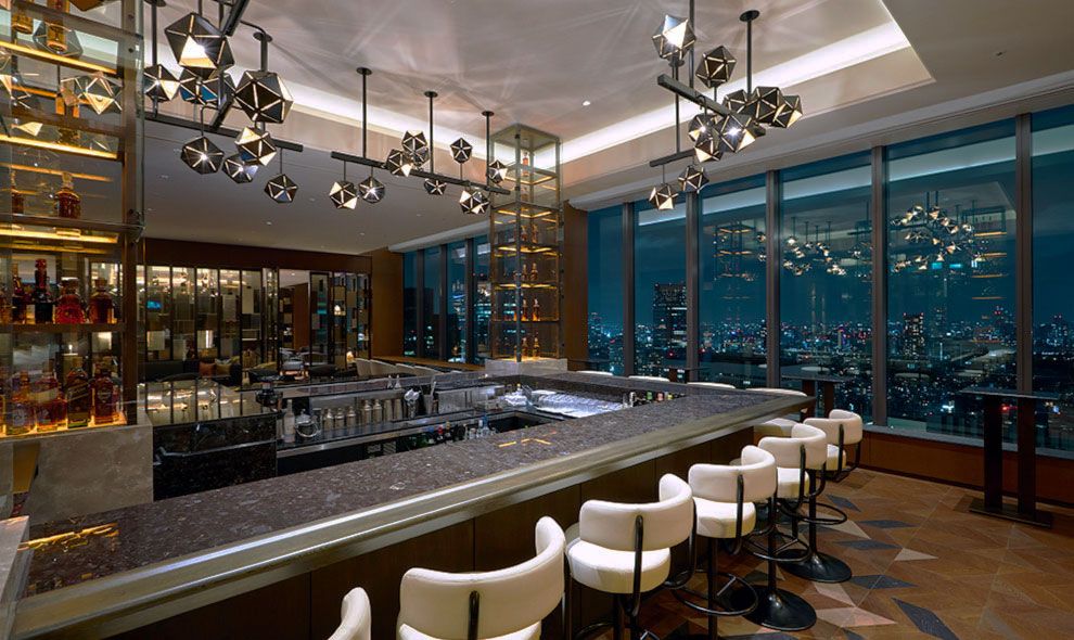 Starlight Bar with distinctive star-shaped lighting fixtures and panoramic Tokyo skyline views—quintessential mid-century luxury (Photo: Hotel Okura Tokyo)