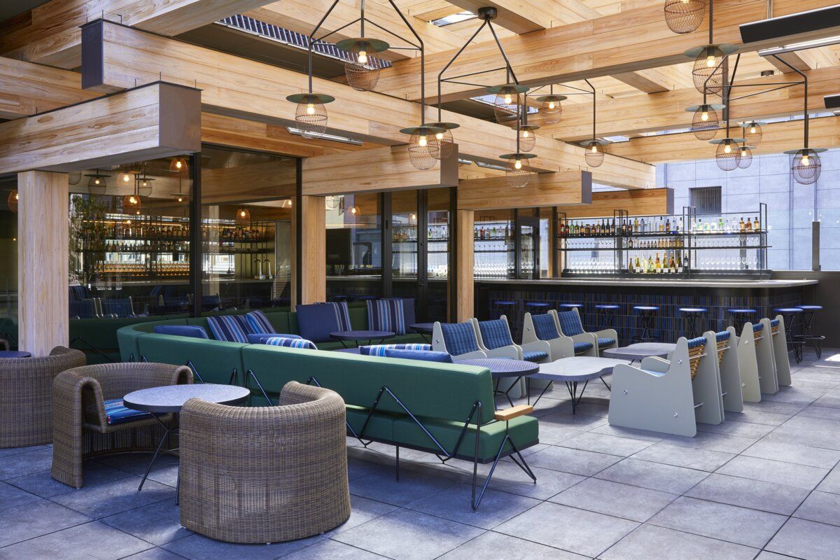 Rooftop lounge at Ace Hotel Kyoto showcasing Kengo Kuma's timber ceiling design, geometric lighting fixtures, and modular mid-century inspired seating (Photo: Ace Hotel Kyoto)