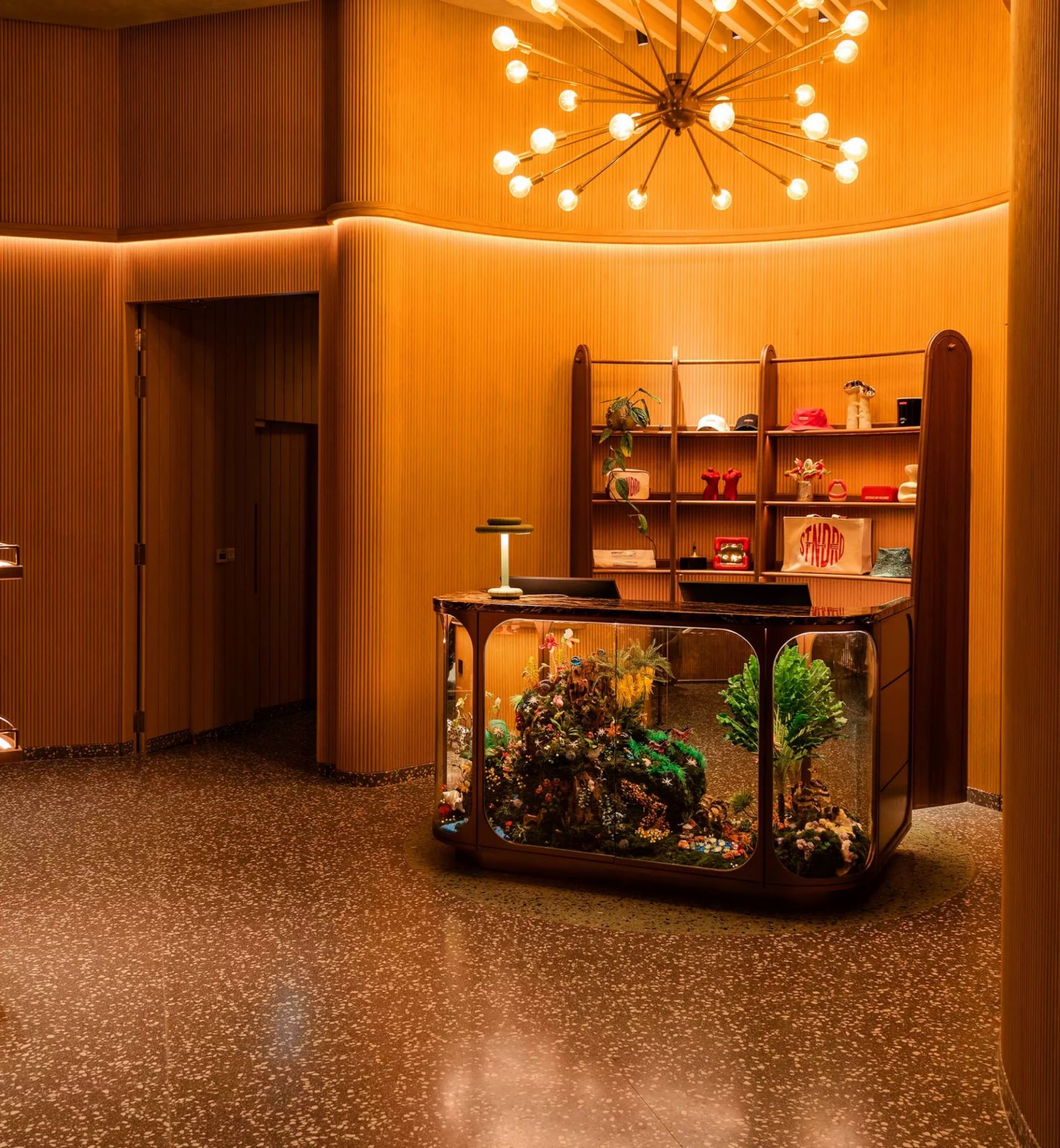 Reception area at The Standard Singapore with terrazzo flooring, ribbed wooden walls, and statement Sputnik light fixture—a thoughtful reinterpretation of 1960s hotel design (Photo: The Standard Singapore)