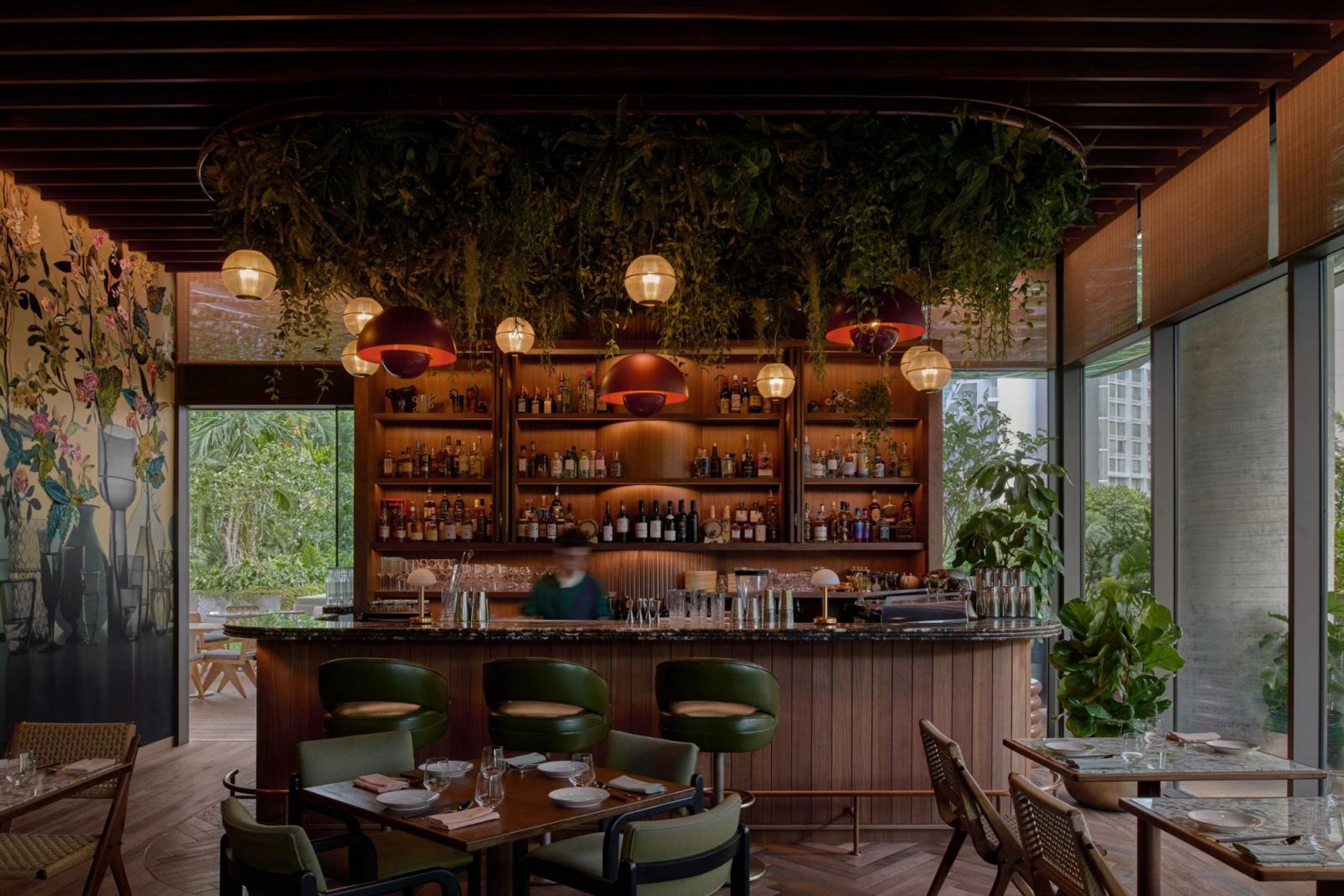 The Standard Singapore’s Kaya with overhead greenery, globe pendants, and copper dome lights—blending tropical elements with mid-century modern design principles (Photo: The Standard Singapore)