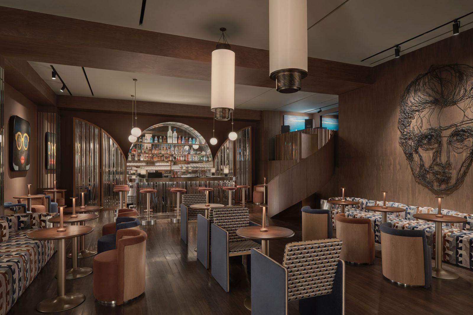 Art Deco-inspired cocktail lounge at Public House Hotel Bangkok featuring arched metal details, cylindrical lighting, and geometric upholstery—a sophisticated tribute to 1930s design influences with contemporary Asian nuances  (Photo: Public House Hotel Bangkok)