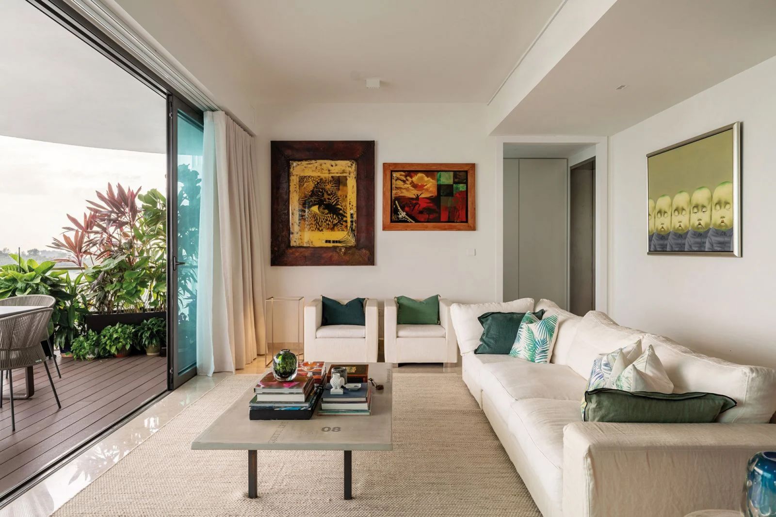 Large glass panes blur the line between the interior spaces and the breezy outdoor areas