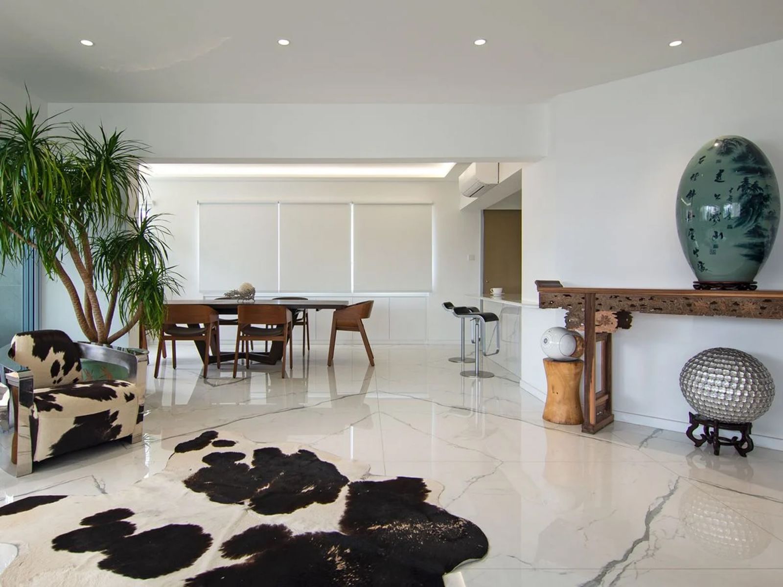 Matching cowhide patterns on the armchair and rug enliven this corner of the living area