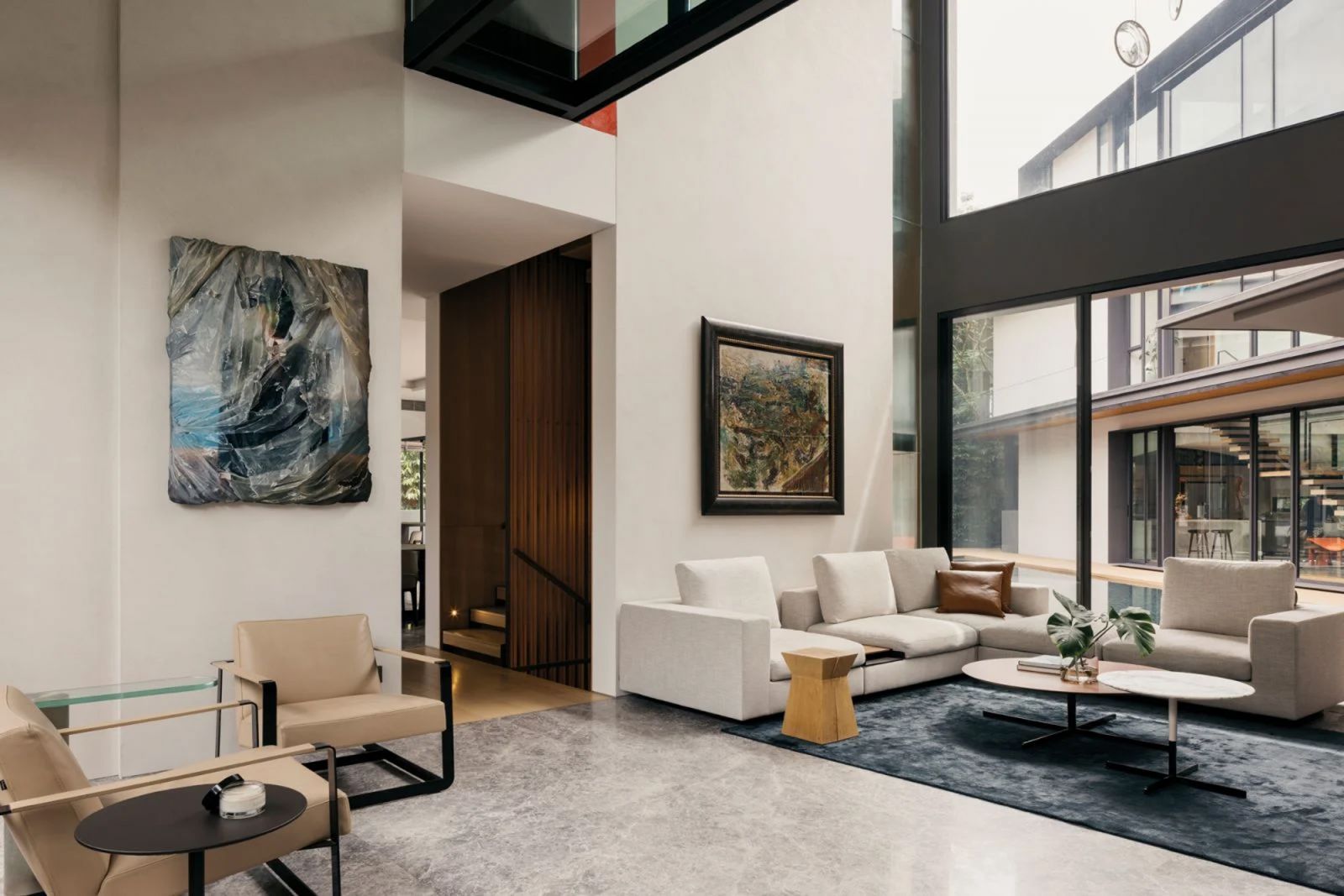 In the living room, a painting by Robin Eley is matched with a minimalist sofa from Walter Knoll