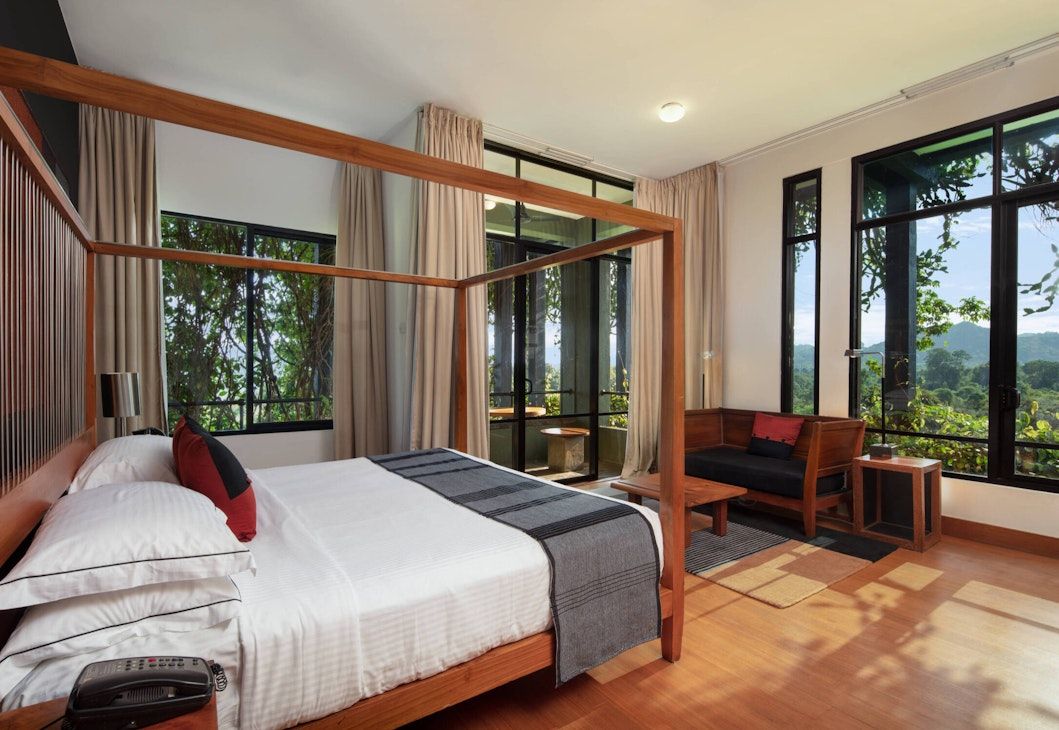 Four-poster bed suite at Heritance Kandalama with panoramic views of Sri Lanka’s Cultural Triangle, demonstrating Bawa’s modernist principle that architecture should serve as a frame for experiencing the surrounding landscape (Photo: Heritance Kandalama)