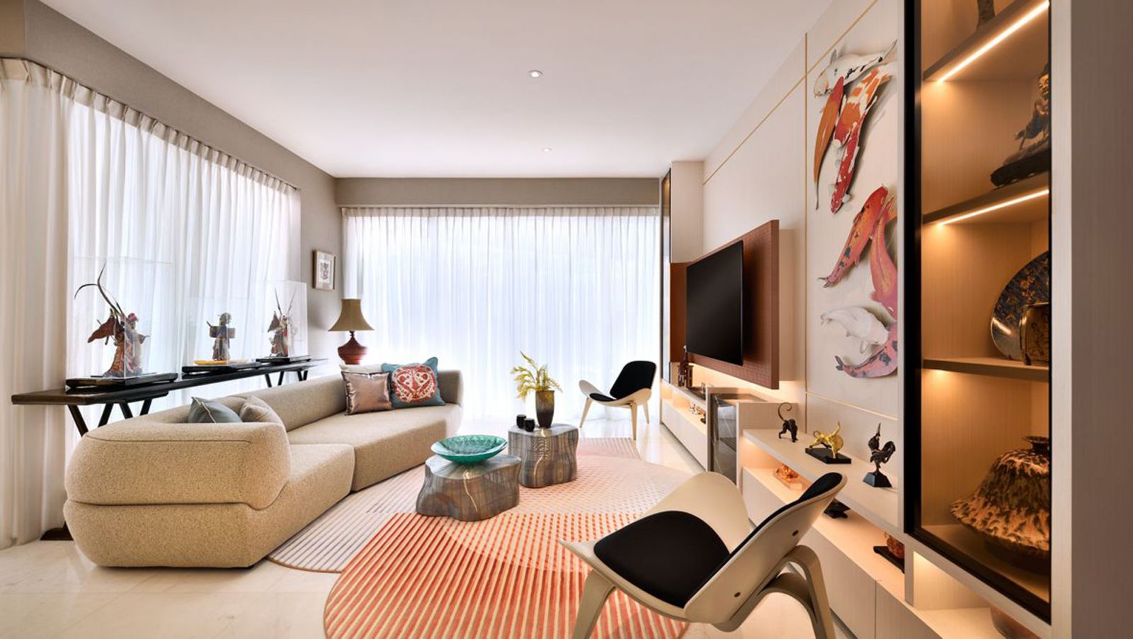 An overview of the Sentosa apartment's living room, in which an artwork featuring a school of koi fish catches the eye, as designed by Prestige Global Designs