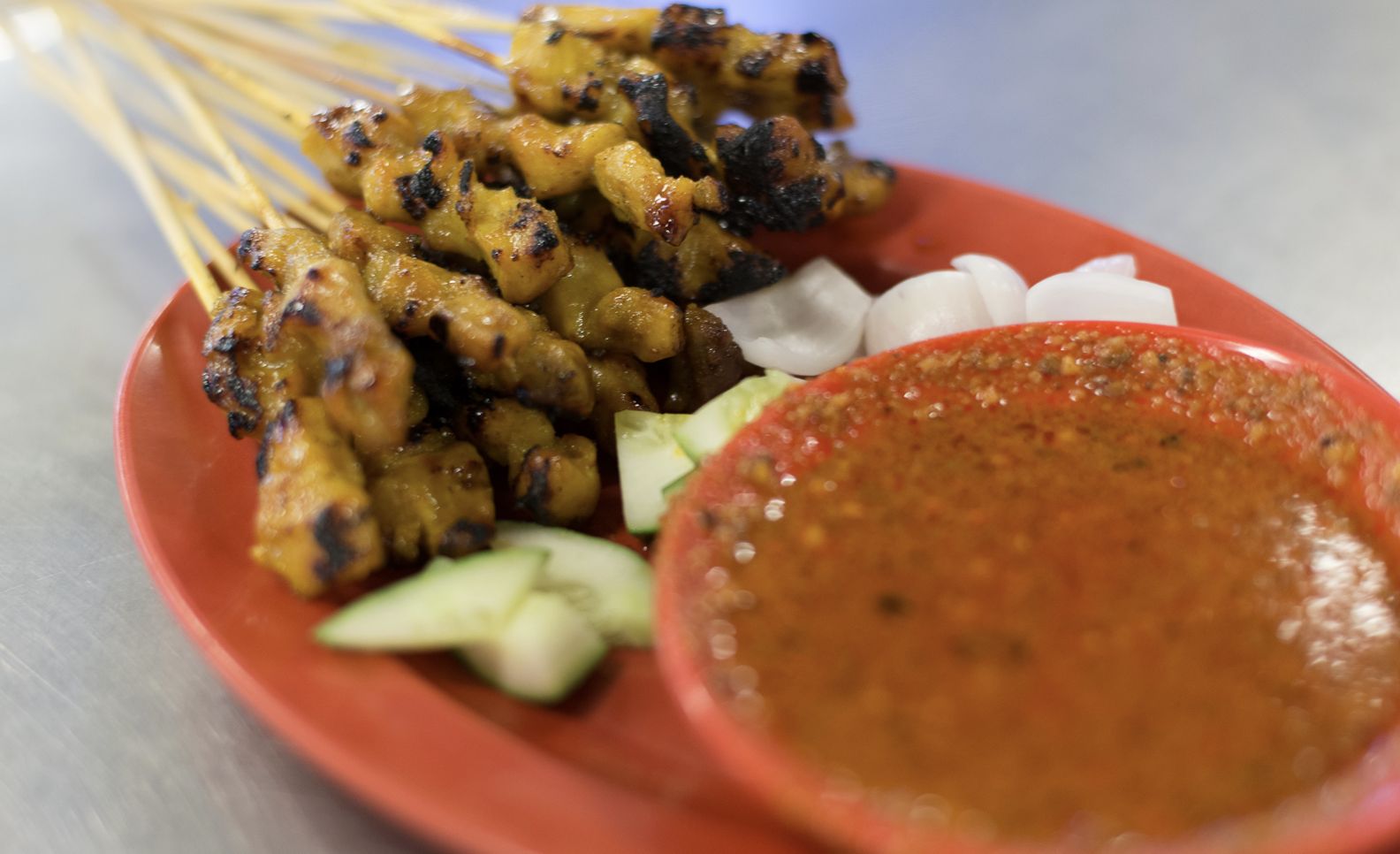 Satay ayam with all the add ons, with kuah kacang, a peanut sauce