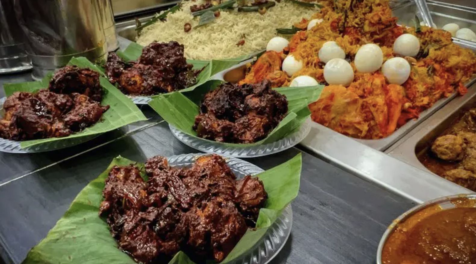 Buffet style section of a nasi kandar joint, picking between biryani or normal white rice