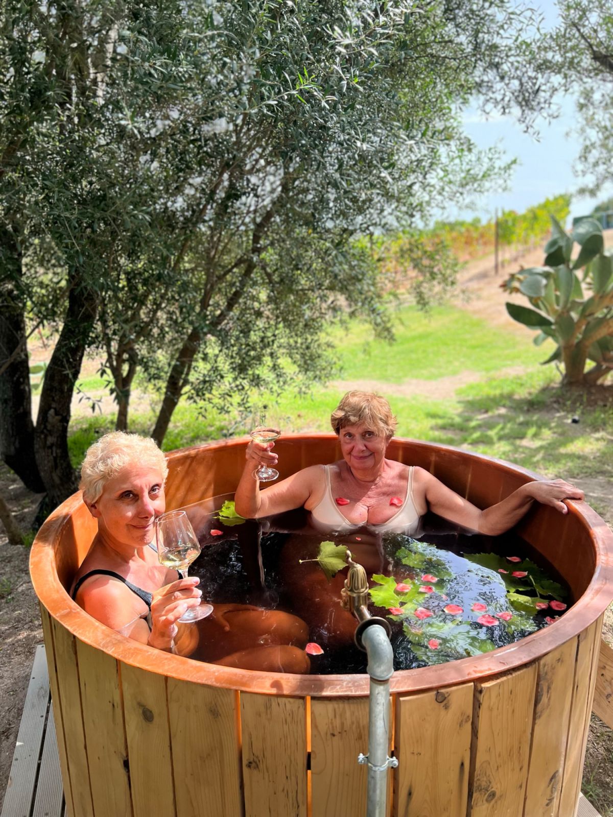 Two guests at Cantina Murales enjoying the wine bath