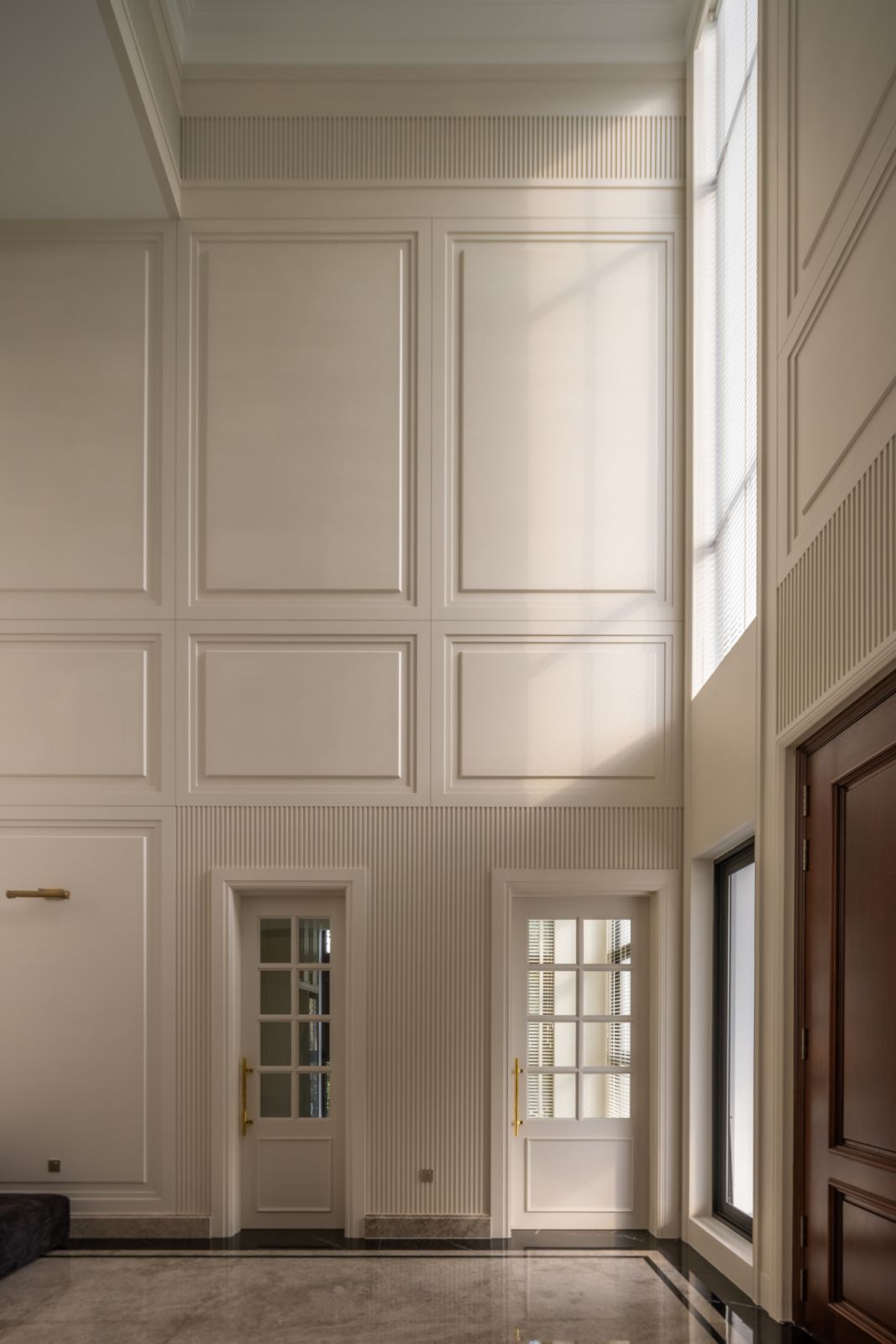 High ceilings and large windows make for an impressive foyer