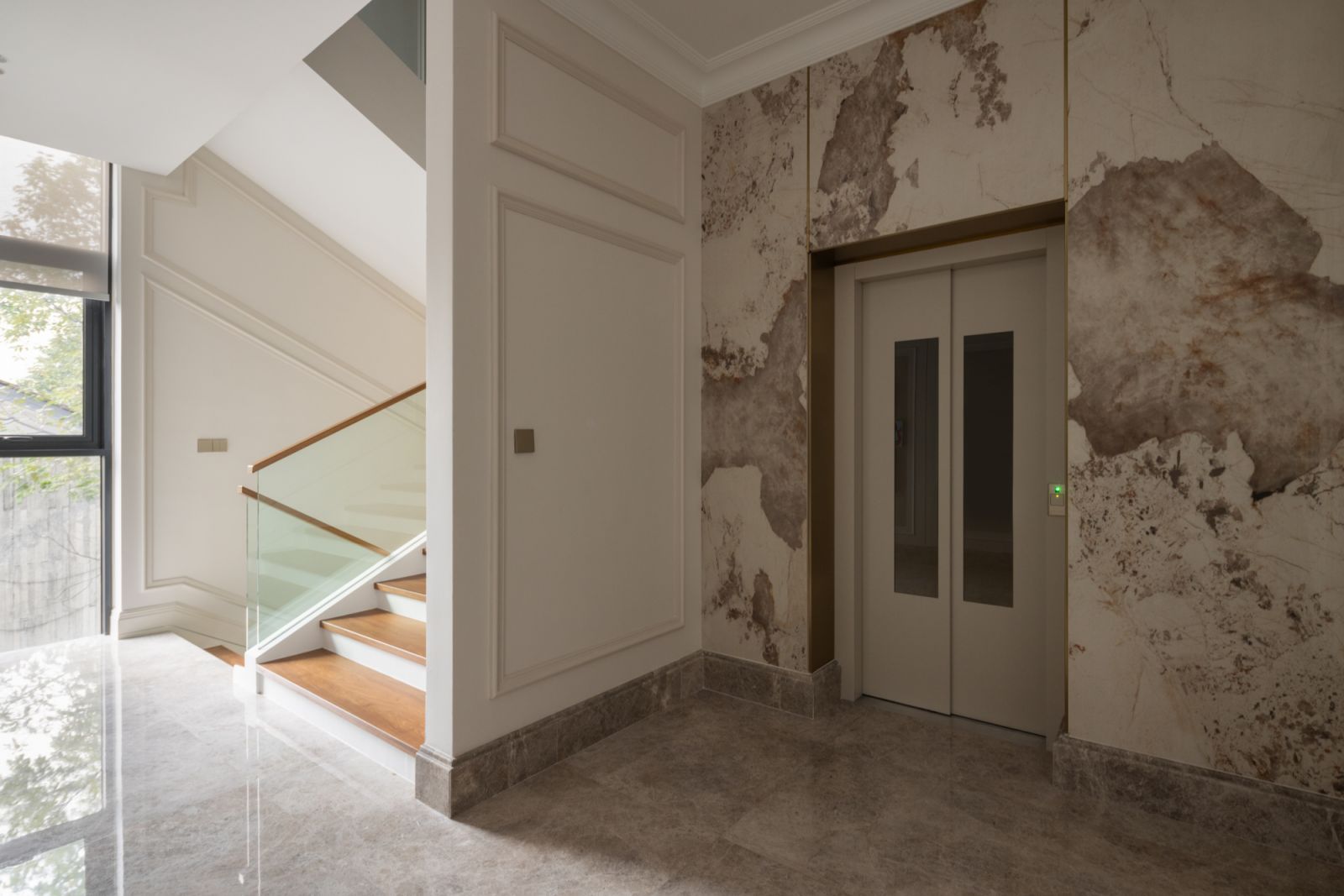 Lift lobby with refined architectural detailing, marble flooring and discreet lighting, providing convenient vertical circulation between the four storey