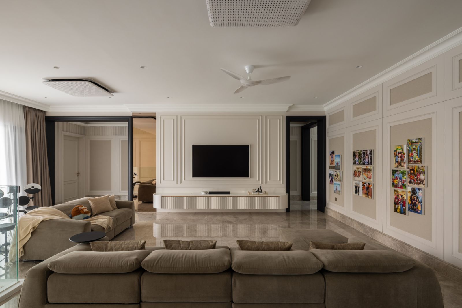 Expansive view of the formal living area showcasing its harmonious proportions, refined furnishings, and strategic placement adjacent to the outdoor pool