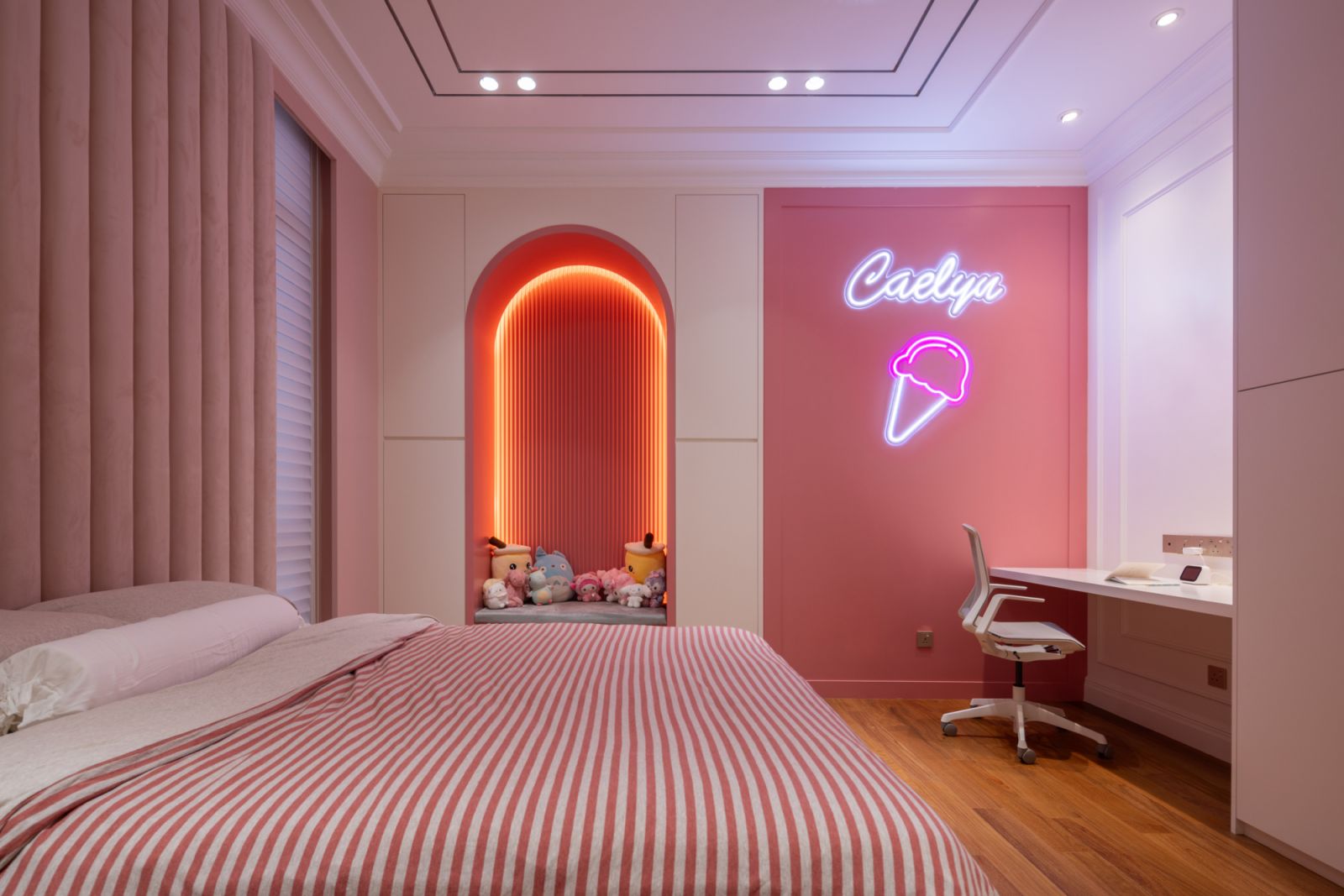 Personalised children’s bedroom featuring custom pink accents, neon lighting and integrated storage designed for the family’s youngest daughter.