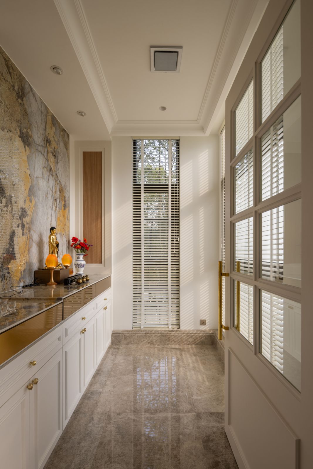 The altar room is bathed in natural light, featuring variable-height sintered stone cabinetry, classical wainscoting, and thoughtfully arranged spaces
