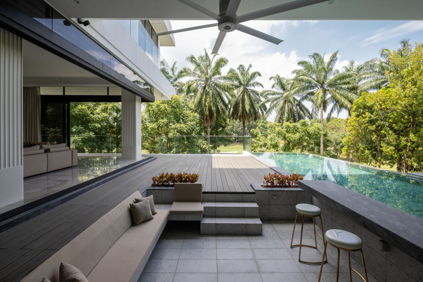 The sunken deck adjacent to the swimming pool creates a conversation area positioned to enjoy the surrounding golf park views