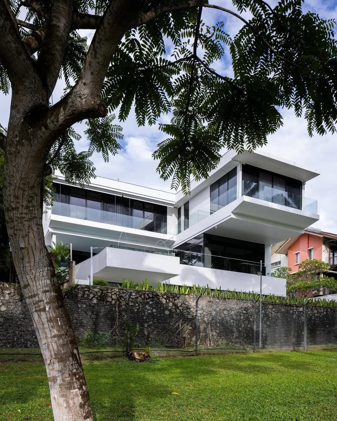 Elegant rear elevation of the four-storey bungalow overlooking landscaped gardens with seamless indoor-outdoor living spaces