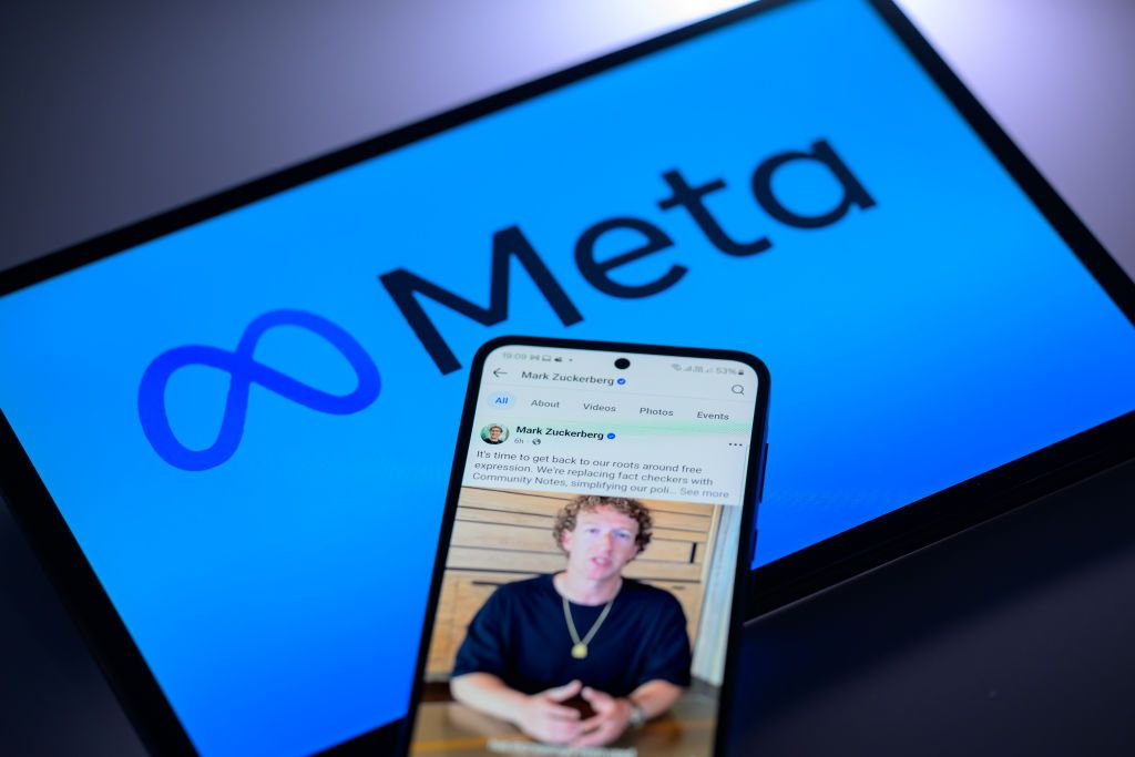 Mark Zuckerberg's personal Facebook account is displayed on a mobile phone with the Meta logo visible on a tablet screen in this photo illustration in Brussels, Belgium, on January 7, 2025. (Photo by Jonathan Raa/NurPhoto via Getty Images)