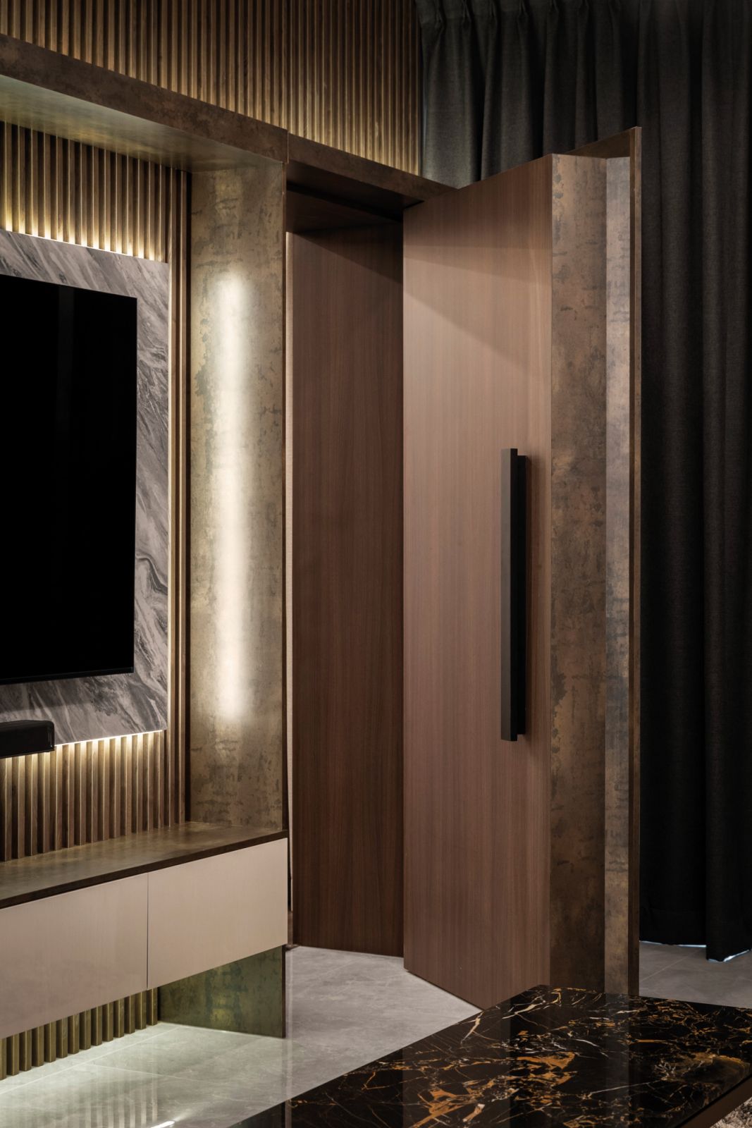 The shelves flanking the TV feature wall in the living room hide an unexpected passageway