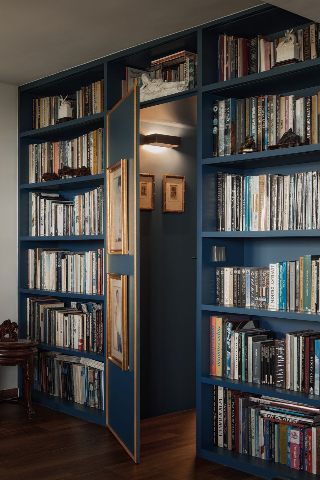 These shelves conceal a secret passageway, behind which a bedroom is revealed