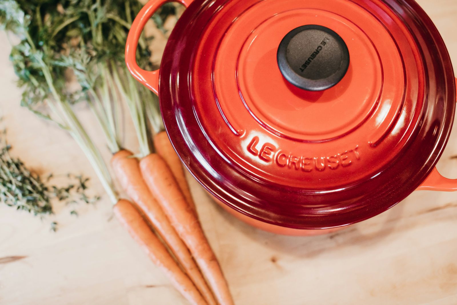 "The iconic Flame colored Le Creuset Dutch oven its signature vibrant orange-red enamel and embossed brand name (Photo: Unsplash/Becca Tapert)