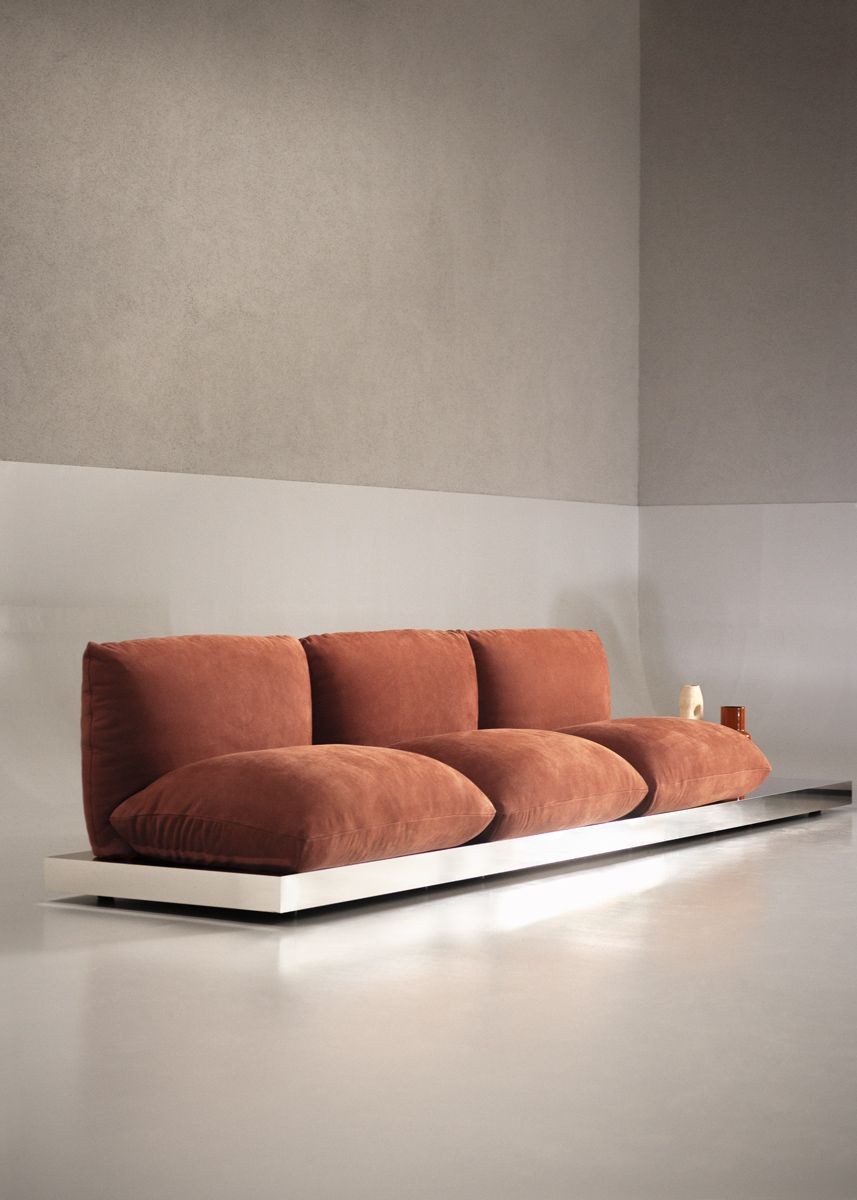 The Aura sofa with aluminium base is a throwback to retro conversation pit