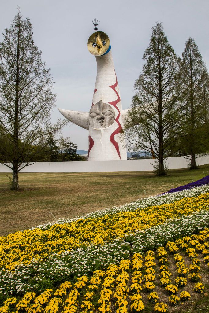OSAKA, JAPAN - 2017/04/20: Tower of the Sun at Osaka Expo Park is about 65 meters high with three faces; The Golden Mask is on top made of a round steel plate, the Face of the Sun is on the front composed of a round fiberglass plastic plate and the Black Sun on the back is a mosaic made of pieces of ceramic plates. The tower is hollow. The red lightning on the front and the coronas on the back are made with Italian glass mosaic tiles. (Photo by John S Lander/LightRocket via Getty Images)