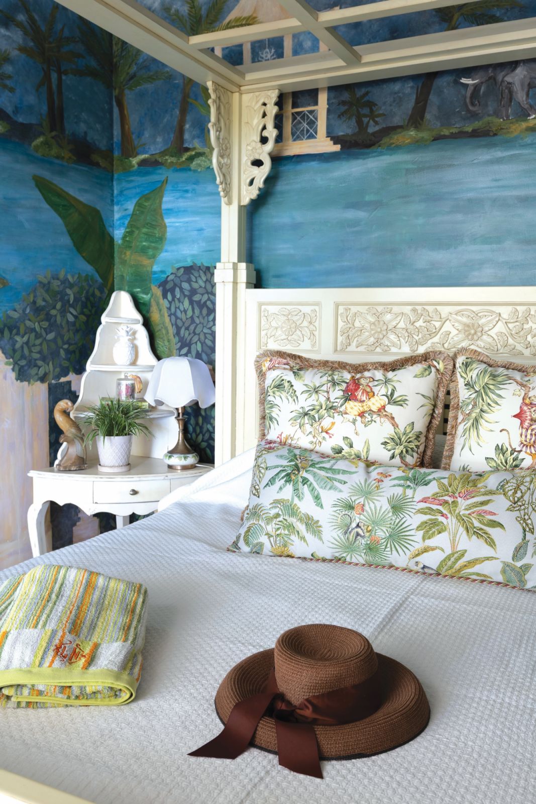 The well-loved carved four poster bed in the guest room
