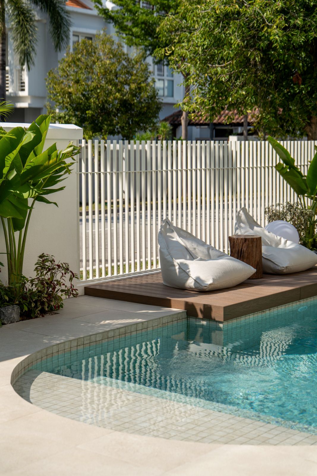 Contemporary tropical pool design with vertical privacy screen and lush Malaysian plantings at Straits Quay bungalow