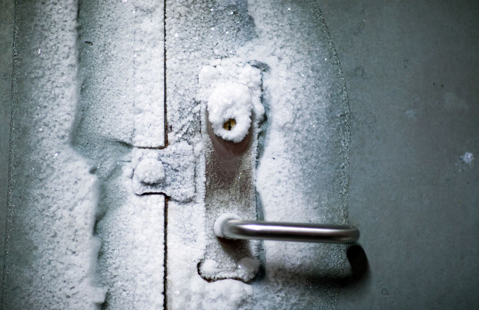 An iced entrance door to the international gene bank Svalbard Global Seed Vault (SGSV) near Longyearbyen on Spitsbergen, Norway, 08 April 2015. During permafrost, the germs of more than four million plants such as rice, corn, beans, and potatoes are collected, frozen, and secured for the future in three mountain caves. Photo: Jens Büttner | usage worldwide (Photo by Jens Büttner/picture alliance via Getty Images)
