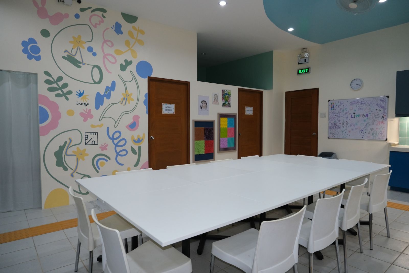 An engaging mural art adjacent to the dining table ignites a positive embrace among the residents, after a redesign of Hospicio De San Jose by Benilde interior design students
