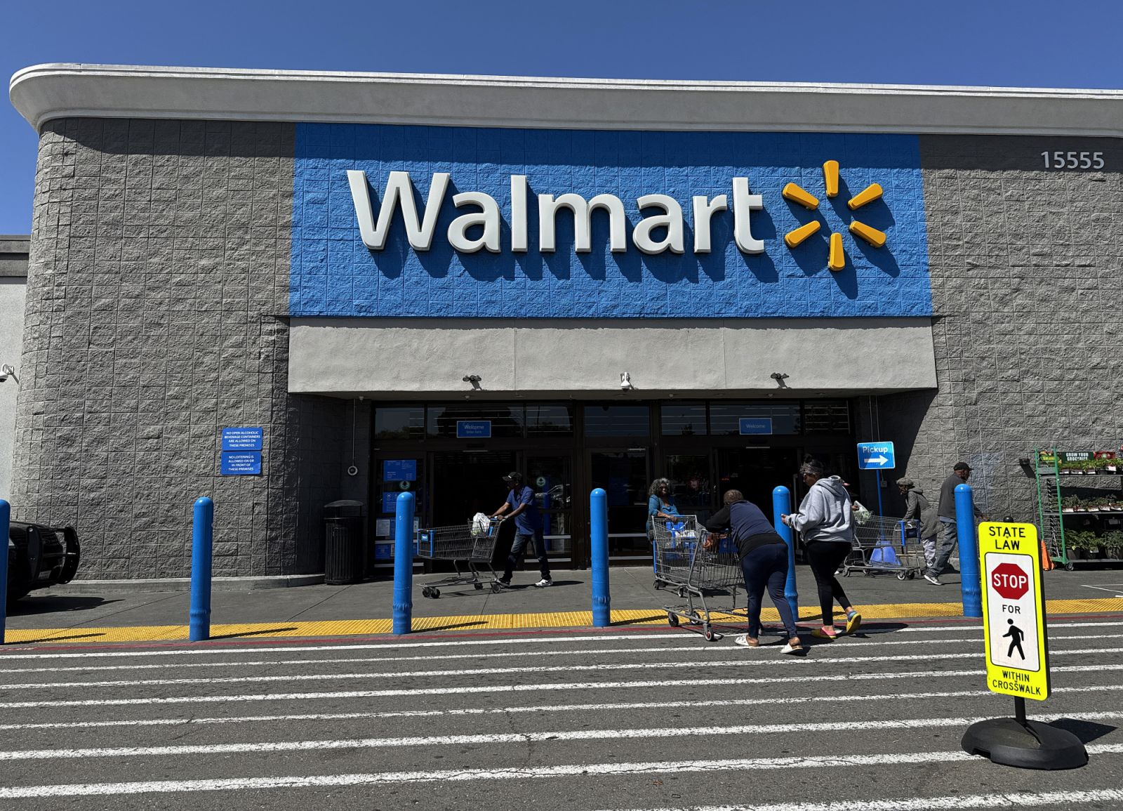 SAN LEANDRO, CALIFORNIA - APRIL 09: Customers enter a Walmart store on April 09, 2025 in San Leandro, California. Walmart is pulling its first-quarter earnings estimates as President Donald Trump’s new tariffs could impact its profits in the first quarter. (Photo:Getty Images)