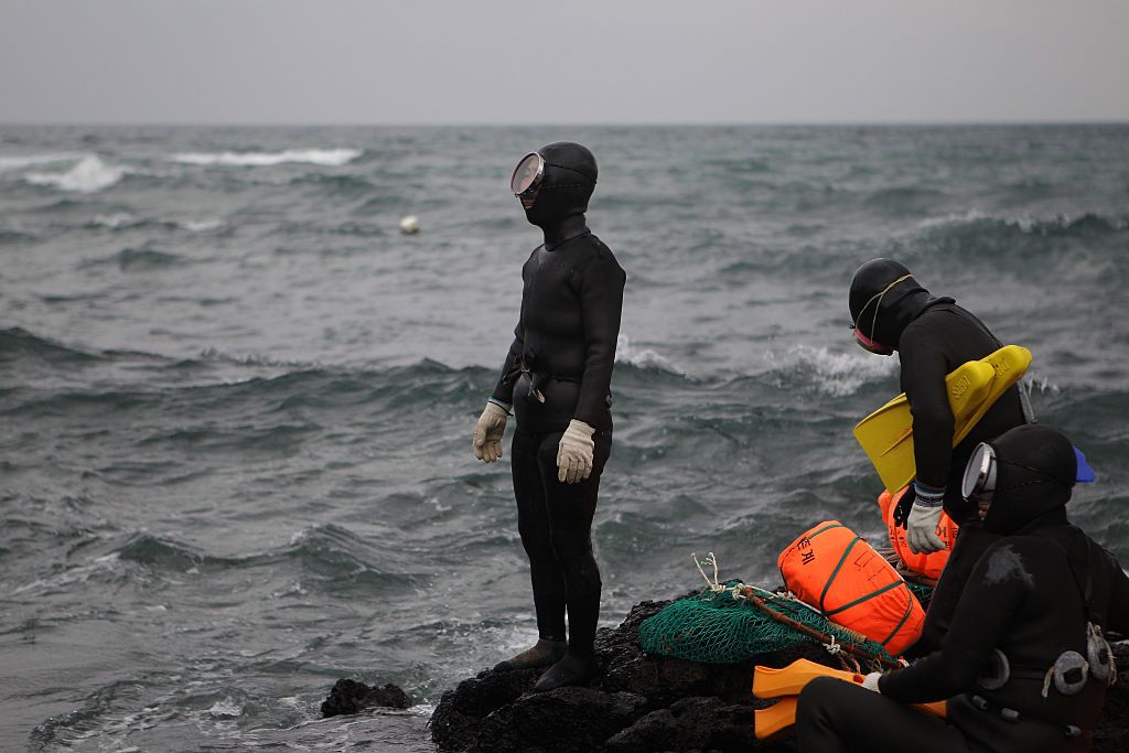 JEJU, SOUTH KOREA - NOVEMBER 06:  South Korean haenyeo prepare for swimming to catch turban shells and abalones on November 6, 2015 in Jeju, South Korea. "Haenyeo," or Sea Women are the female divers in Jeju Island. In 2014, South Korea applied to UNESCO to add the haenyo to its Intangible Cultural Heritage List, and it has been under examination by the committee.  (Photo by Chung Sung-Jun/Getty Images)