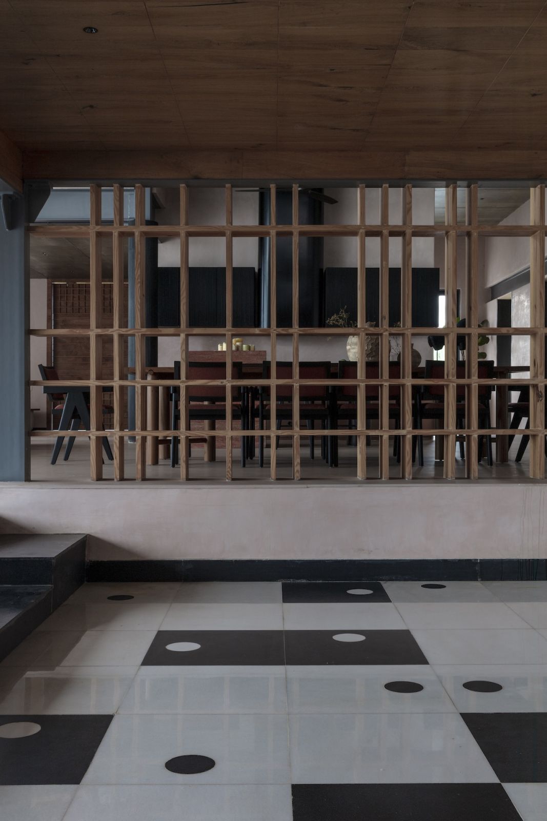 Black granite and white Banswara marble floors making a dramatic chessboard pattern in the sunken television area, at a summer home in Hyderabad, India