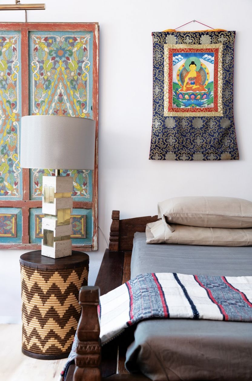 Wilson's guest room features a 1997 Charlie Co painting, After 100 Years, reflecting on a century since Aguinaldo declared independence from Spain. In front of the painting is a narra and balayong round table with antique Ilocano inabel blankets, flanked by a balayong armchair from Batangas (Photo: Jinggo Montenejo)