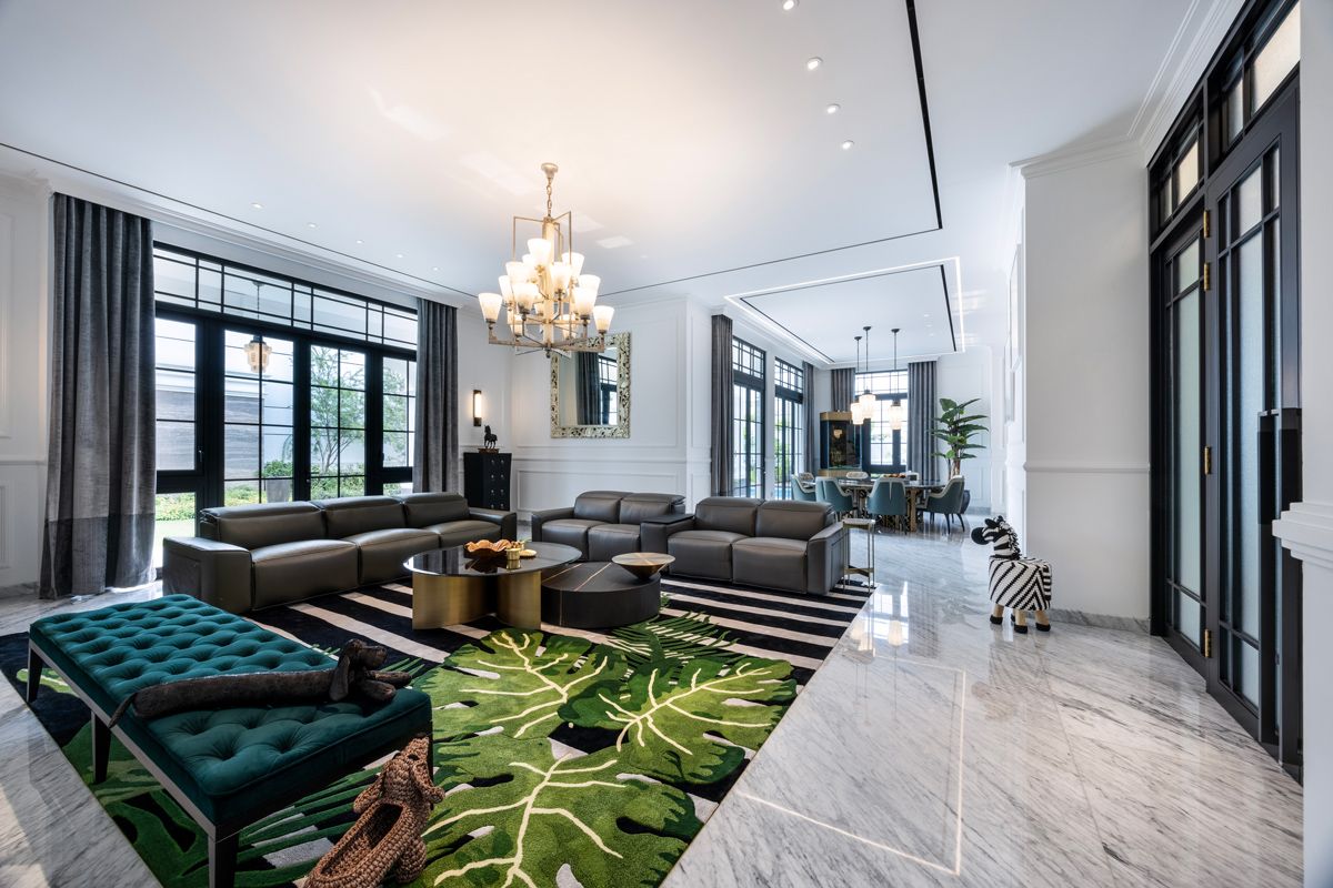 The interior’s predominantly white surfaces allow graphic statement pieces such as an oversized botanical-patterned rug and whimsical animal-shaped decor to shine