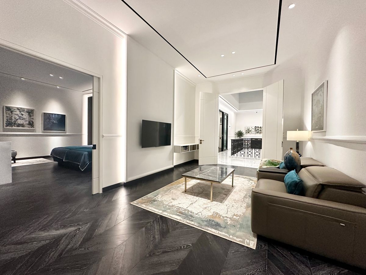 The master suite incorporates a space for watching TV with a plush reclining sofa for supreme comfort;