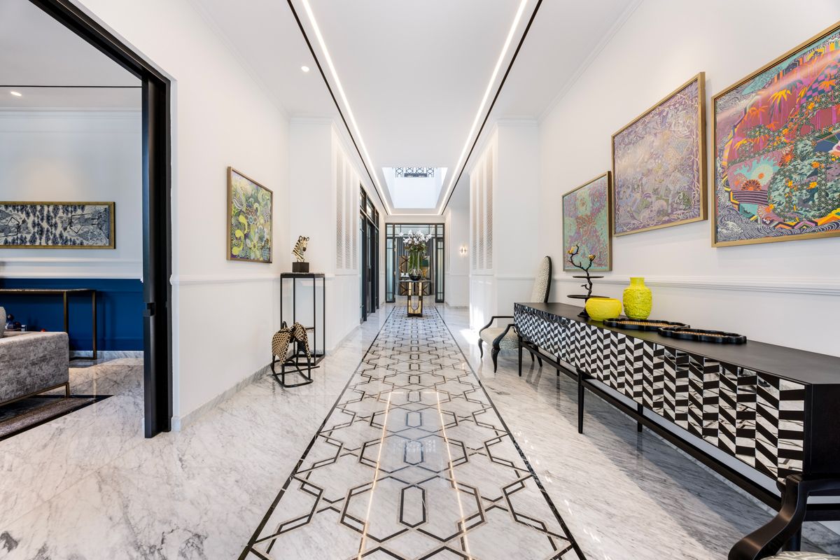 The marble-inlaid foyer makes entering the home a stately procession through an art gallery