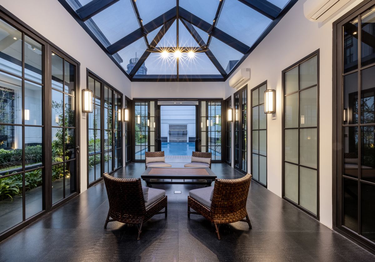 Furnished with leather-woven chairs from Moie Living and a rattan-inlay coffee table, the landed home's gazebo serves as a versatile space from which to admire the ever-changing sky