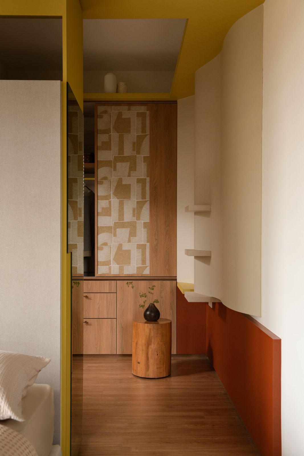 Mustard yellow built-ins create a vibrant frame for the integrated home workspace, where the scent designer homeowner develops her aromatic creations