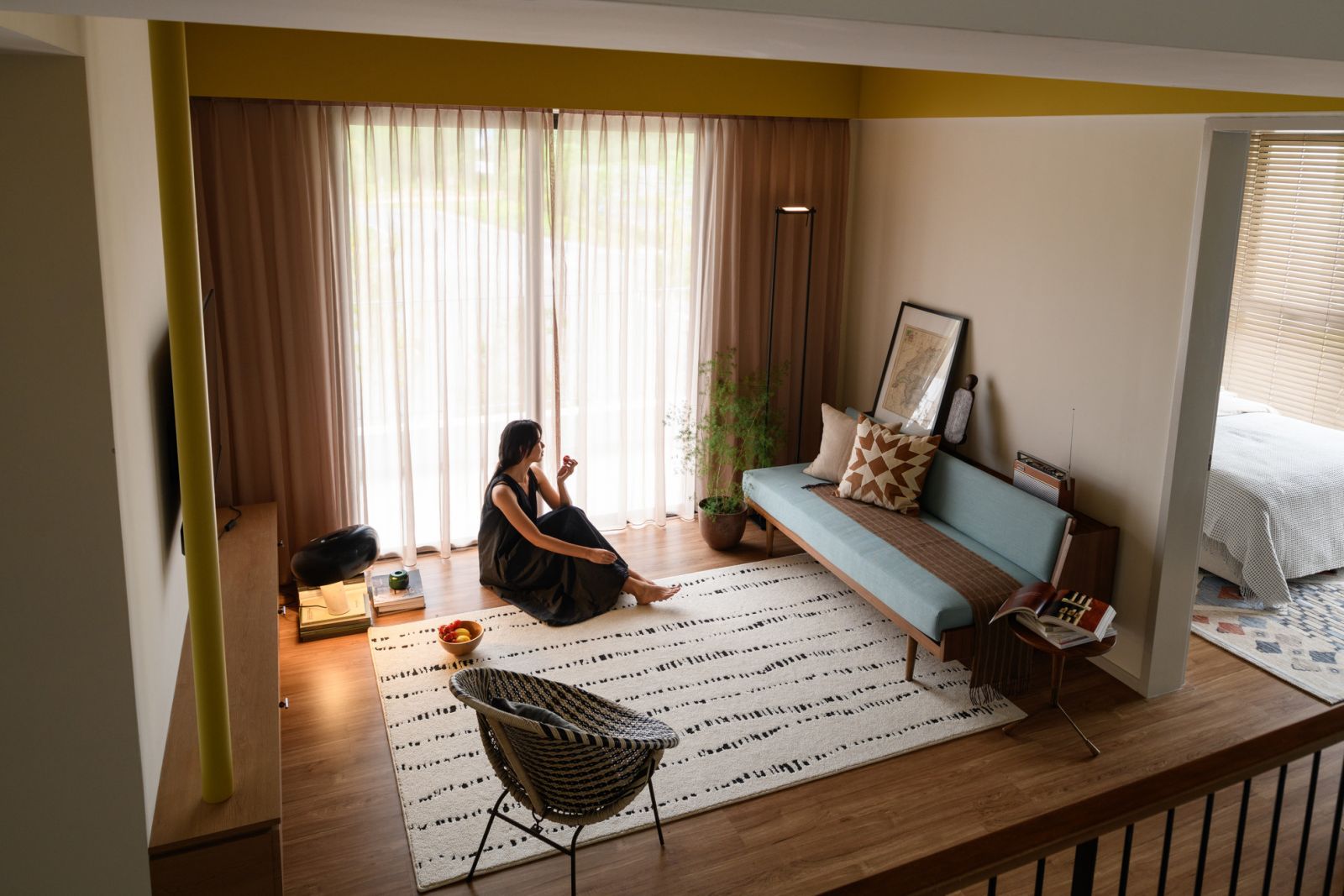 The split-level design creates intimate conversation areas within the open concept layout. This elevated perspective showcases how different zones flow together while maintaining distinct functions throughout the home